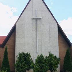 shrubs in front of the exterior cross
